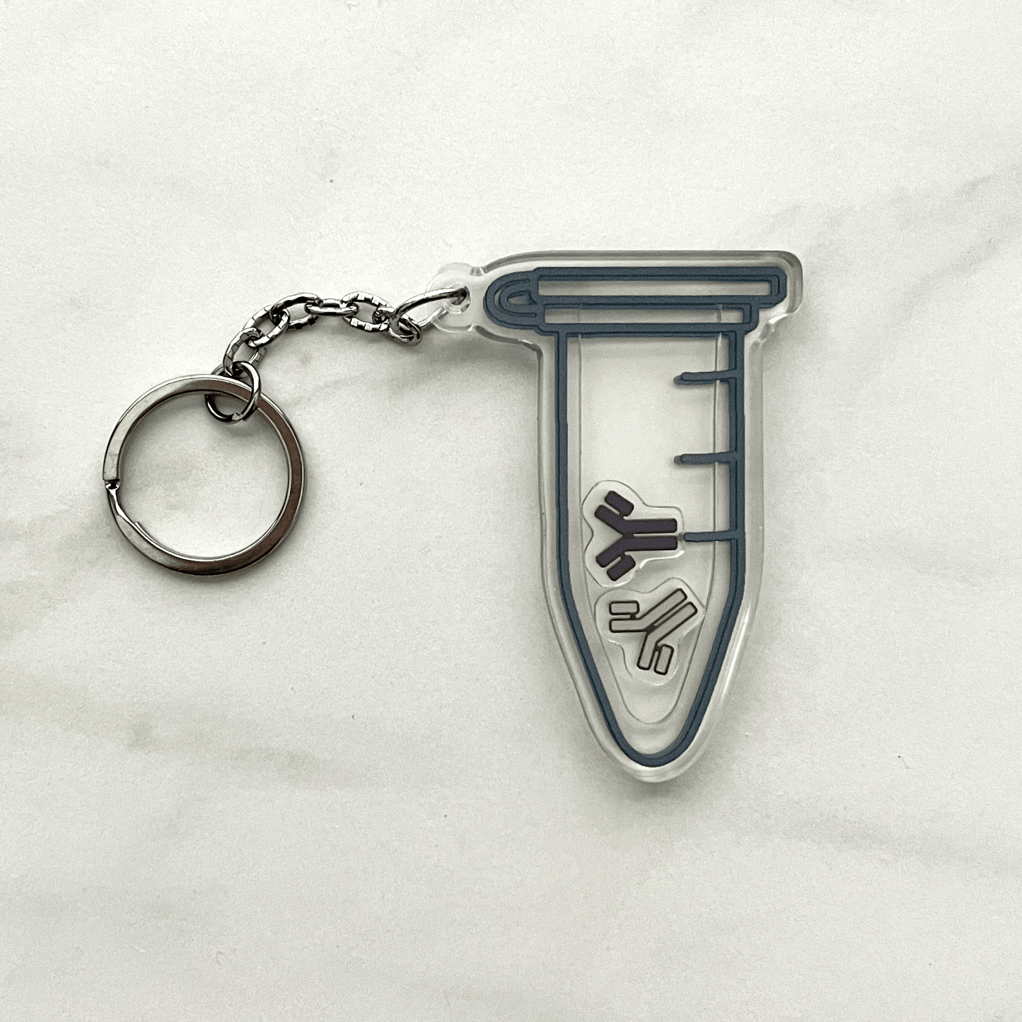 Acrylic keychain of a microcentrifuge tube containing one purple and one gray antibody